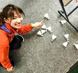 Japanese girl pointing to badminton shuttles