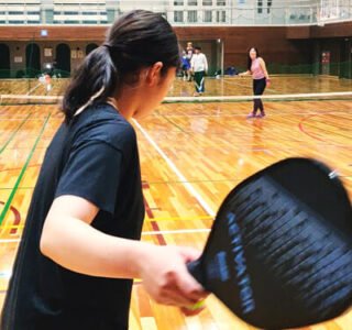 Japanese girl hitting a pickleball